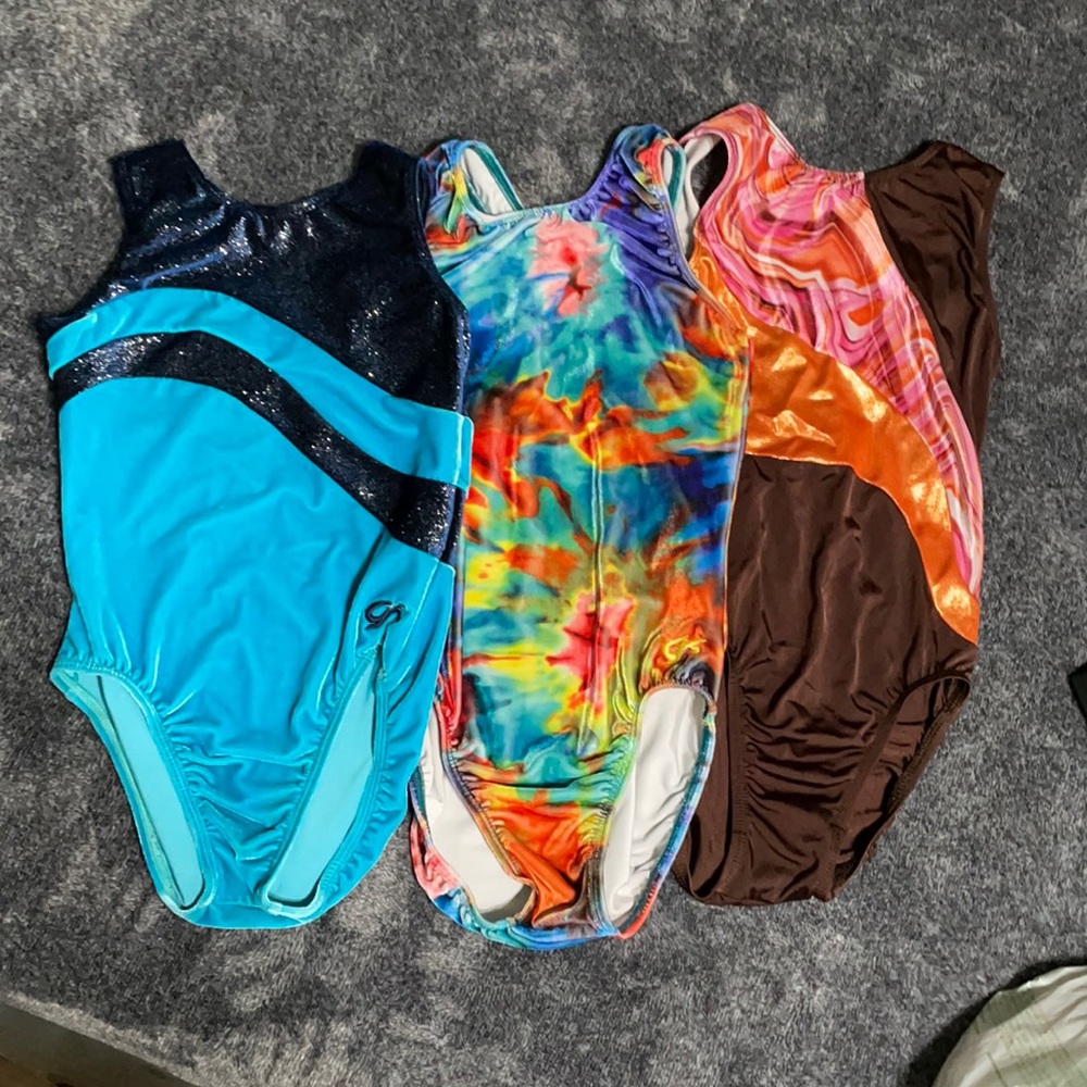 Three GK gymnastics leotards